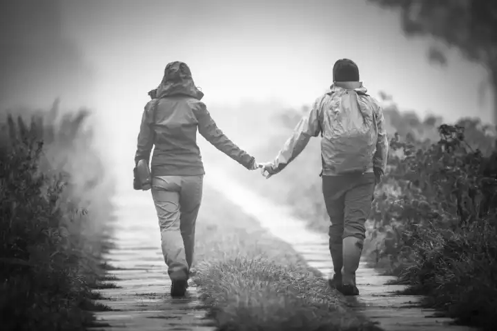 couple holding hands on a walk
