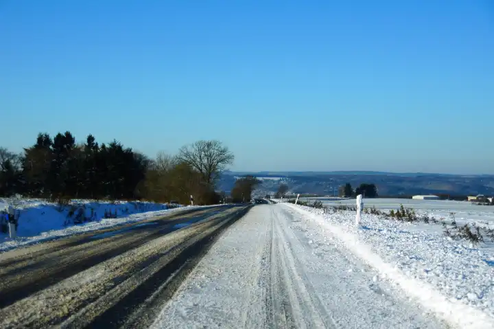 down the driven snow on the road near Starkenburg in the Hunsrück
