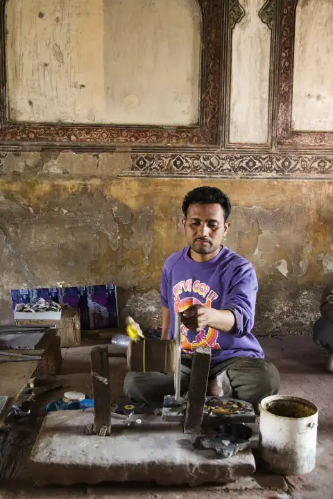 indian man grinds glass, North India, India, Asia