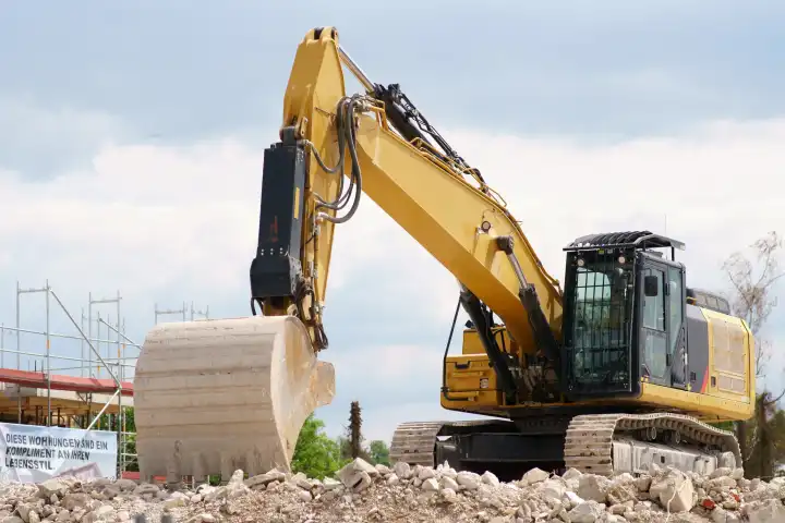 Excavator stands on rubble heap