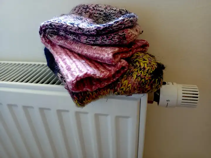 Wool hot socks on radiator for cold winter and lack of gas for heating
