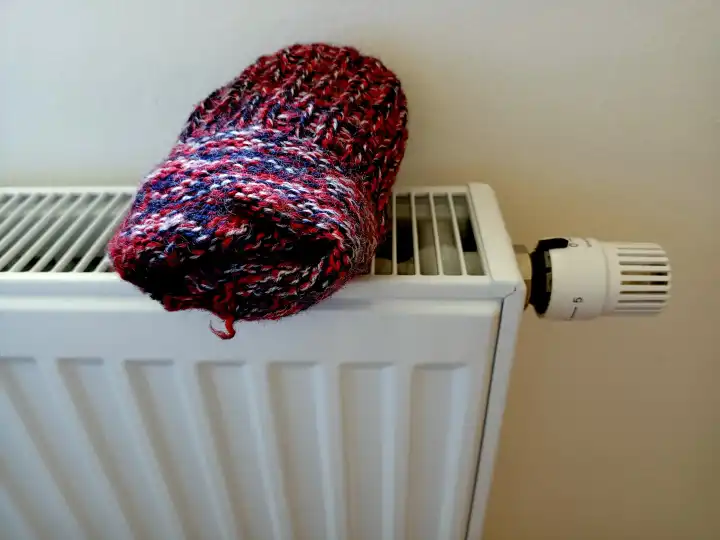 Wool hot socks on radiator for cold winter and lack of gas for heating