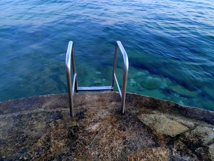 Empty stairs and deck into a sea.