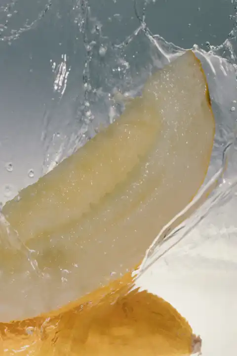 Honeydew melon falls into water