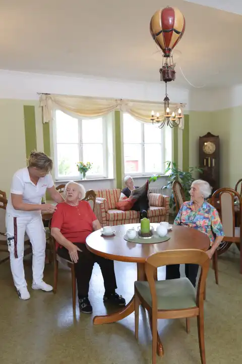 Seniors with nurse in retirement home