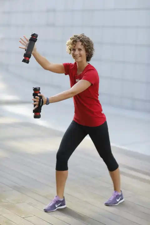 Young Woman doing exercises with dumbbells