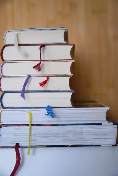 stacked books with cloth ribbons as bookmarks - notebook ribbon