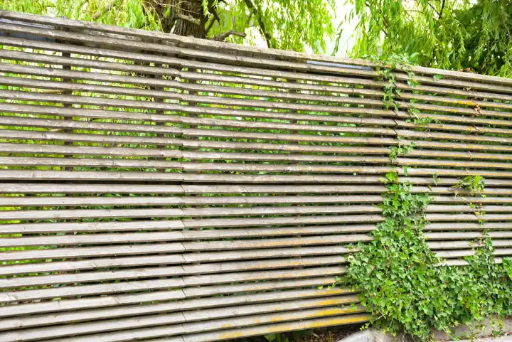 Wooden garden fence also serves as a privacy screen - wooden fence