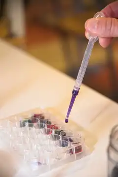Pipette with dye in an experiment and experiment in the laboratory
