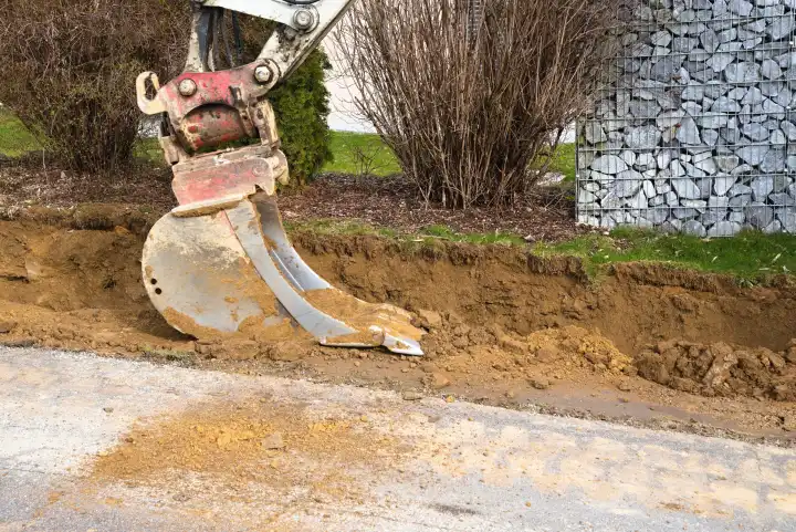 Shovel excavator during earthworks on the construction site - Excavator shovel, close-up