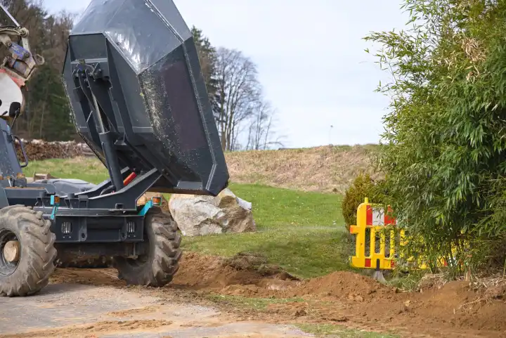 Earth removal with wheel dumper on the construction site - Construction vehicle tipping skip