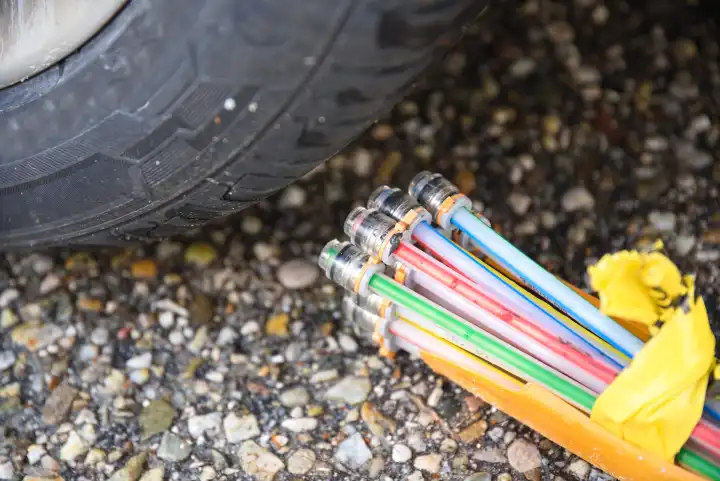 Fiber optic connection on car tire and fast internet connection - close-up