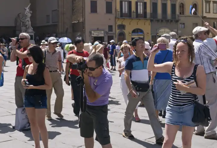 tourists taking pictures in piazza san giovanni square florence