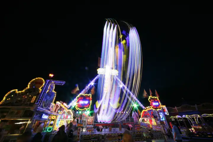ride carousel fairs carnivals in the evening cologne rhineland north rhinewestphalia germany europe