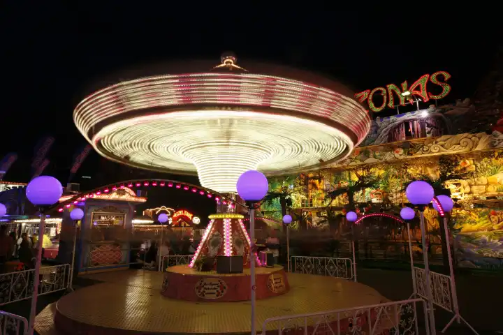 ride carousel fairs carnivals festival light strips in the evening cologne rhineland north rhinewestphalia germany europe