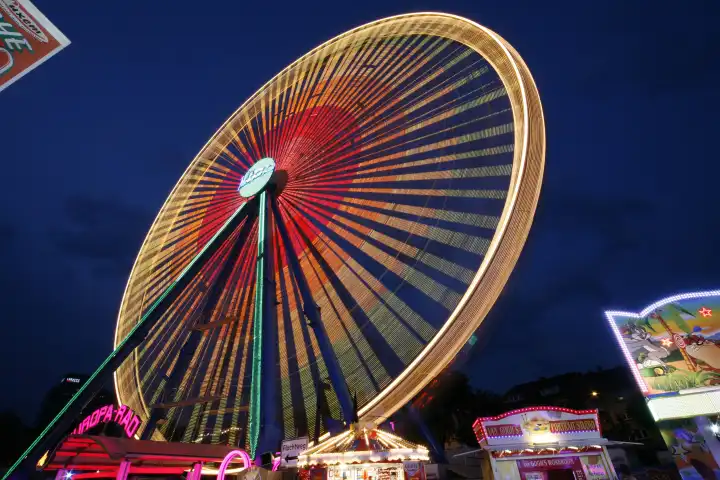 ride ferris wheel carnival fair festival colorful streaks of light in the evening cologne rhineland north rhinewestphalia germany europe
