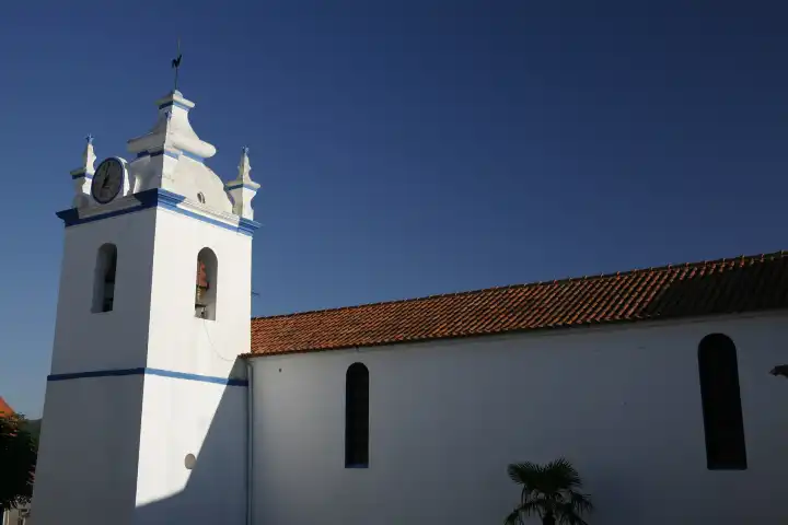 village church church white and blue bell tower clock tower clock tower melides portugal europe