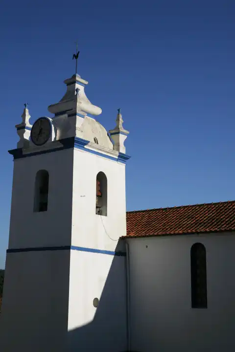 village church church white and blue bell tower clock tower clock tower melides portugal europe