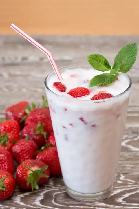 strawberry milkshake with fresh fruits and mint leaves