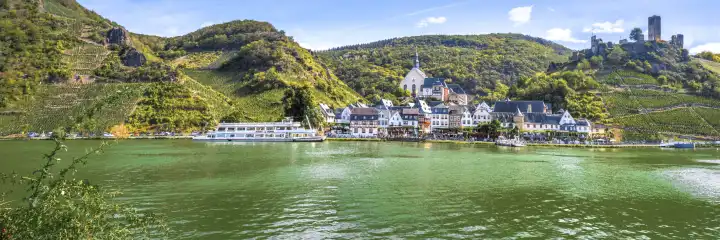 Beilstein at the Moselle river with Metternich Castle, Germany, panorama view with river, ship and vineyards