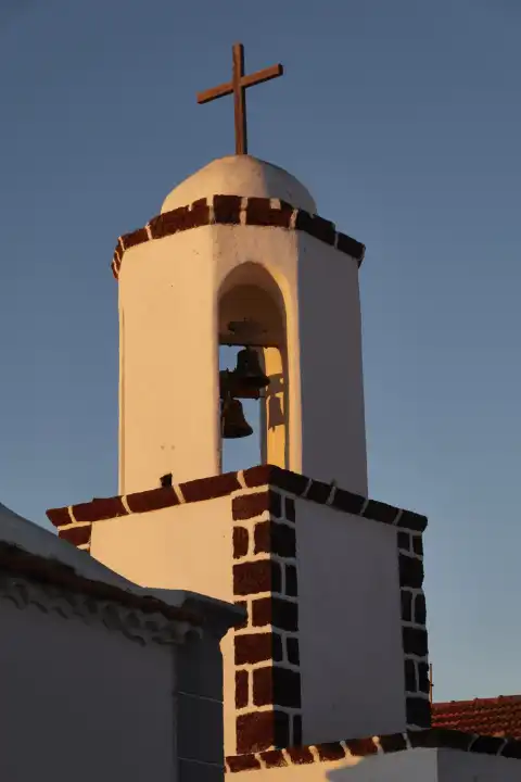 Bell tower of San Antonio Abad Catholic Church in the light of the rising sun, Taibique, El Pinar, El Hierro, Canary Islands, Spain.