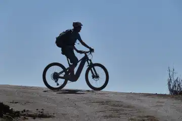 Mountain biker on a mountain road set off against the blue sky. La Palma, Canary Islands, Spain