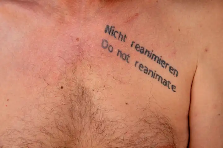 Do not resuscitate . Do not resuscitate. Tattoo on hairy man's chest with instruction not to resuscitate in case of cardiac arrest.