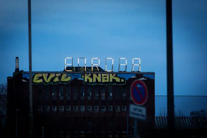 Europe, partially defective neon sign on a building in the evening