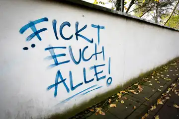 Fuck you all, angry writing graffiti on a wall
