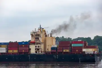 Old container ship with extreme pollutant emissions, exhaust fumes