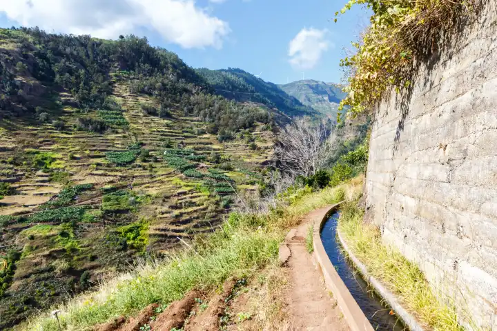 Madeira, Portugal - September 14, 2022: Hiking trail along Levada Nova hiking on Madeira Island, Portugal.