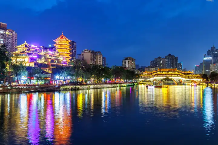Chengdu, China - April 7, 2024: Chengdu Anshun Bridge over Jin River with pagoda at night in Chengdu, China.