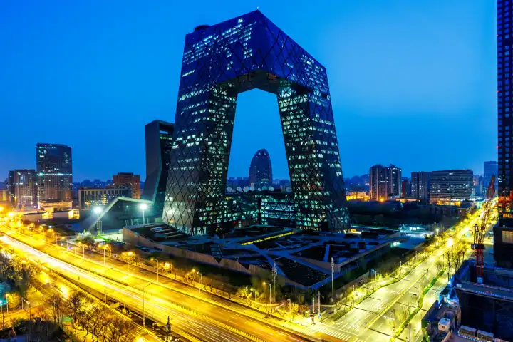 Beijing, China - April 1, 2024: Beijing central business district CBD skyline with the headquarters of Chinese television CCTV at night in Beijing, China.