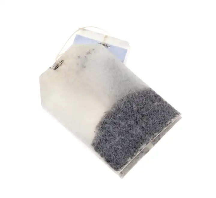 SIngle tea bag over a white background
