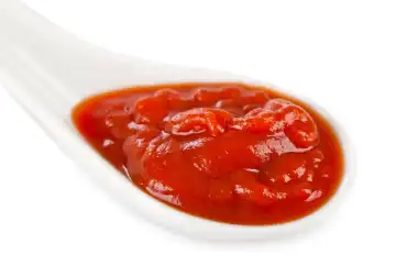 Ketchup in white ceramic spoon