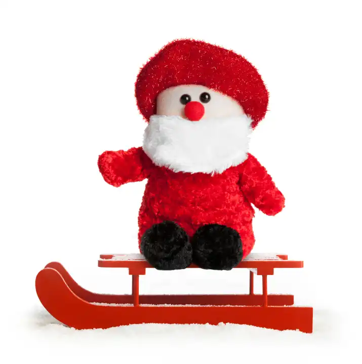 Wooden red sled with Santa Claus plush on white background