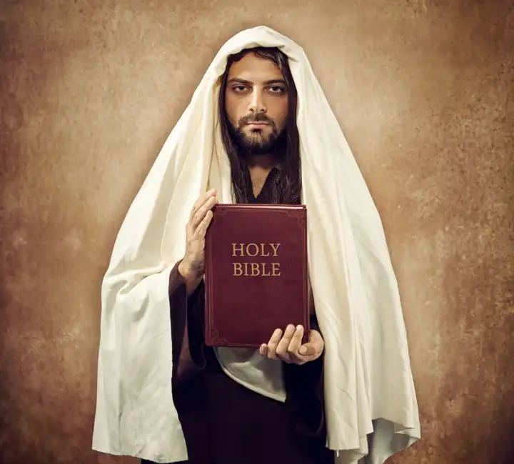 Jesus shows the holy bible on old beige background