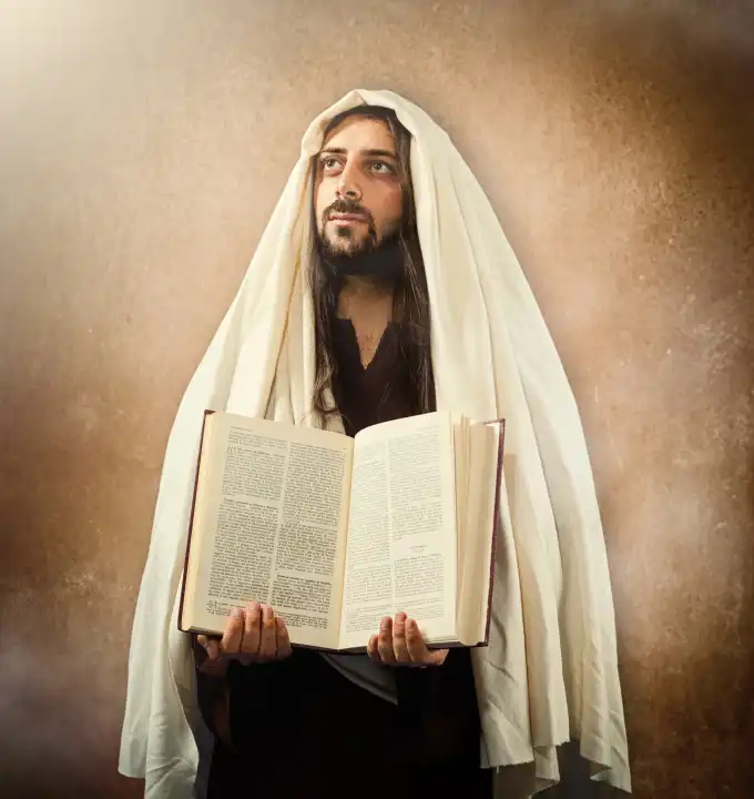 Jesus shows the holy bible on old beige background