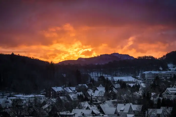 Sunrise over village with snow