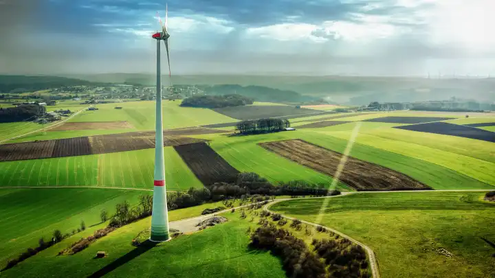 Aerial view of wind turbine in green landscape