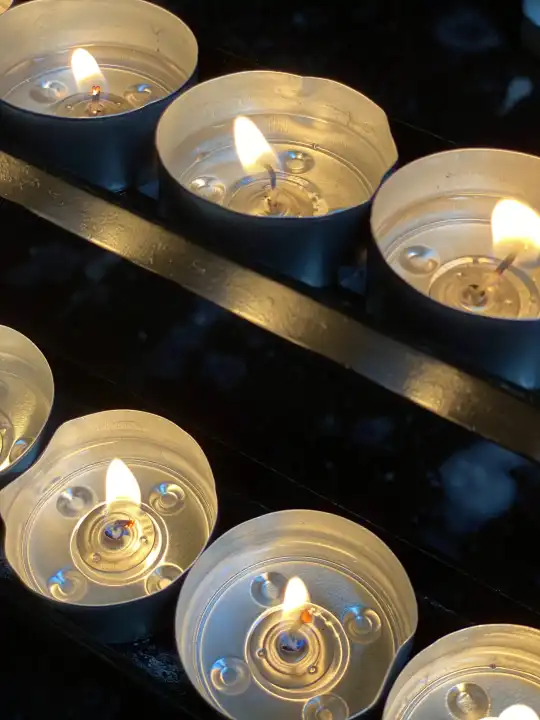 burning tea lights in a church