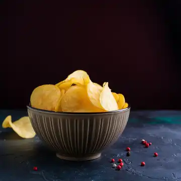 AI generated. A porcelain bowl filled with potato chips