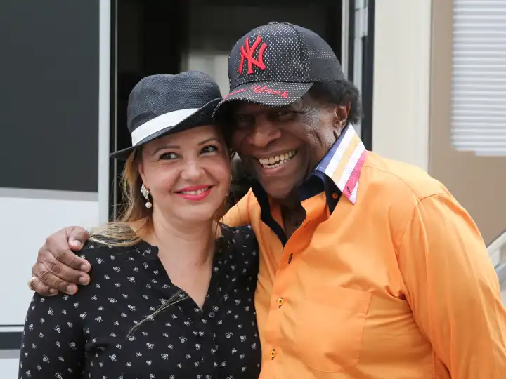 German pop singer Roberto Blanco with his wife Luzandra in front of his caravan during a visit to Magdeburg