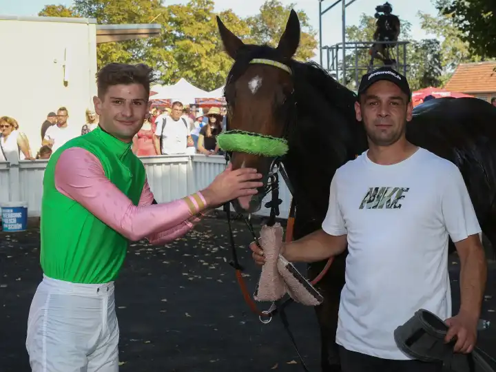 Rider Lukas Delozier with stallion Shayan after the victory in the 3.race on 09.09.2023 on the racecourse Magdeburg