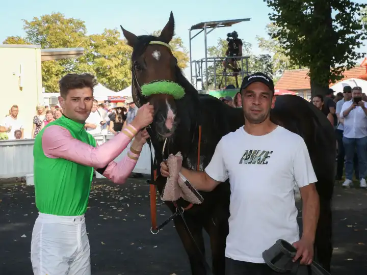 Rider Lukas Delozier with stallion Shayan after the victory in the 3.race on 09.09.2023 on the racecourse Magdeburg