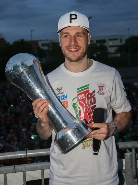 Swedish handball player Daniel Pettersson (SC Magdeburg) with trophy at the reception of the current DHB Cup winner 2024 SC Magdeburg on 15.04.2024 at the GETEC Arena Magdeburg