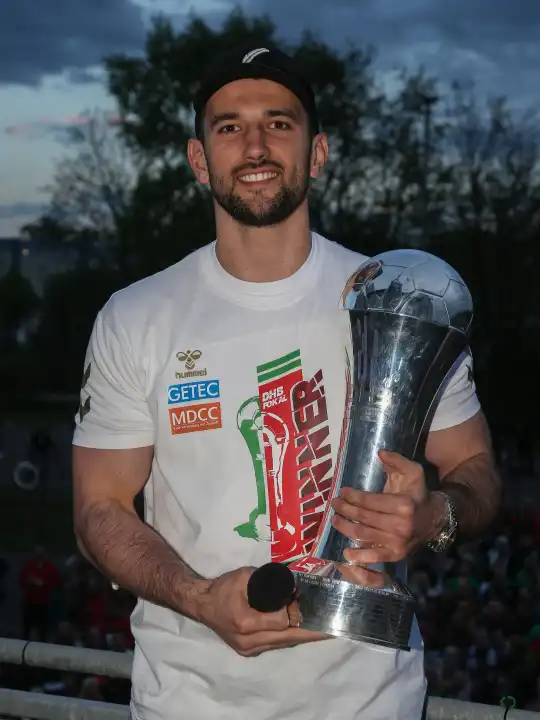 Swiss handball player Lucas Meister (SC Magdeburg) with trophy at the reception of the current DHB Cup winner 2024 SC Magdeburg on 15.04.2024 at the GETEC Arena Magdeburg