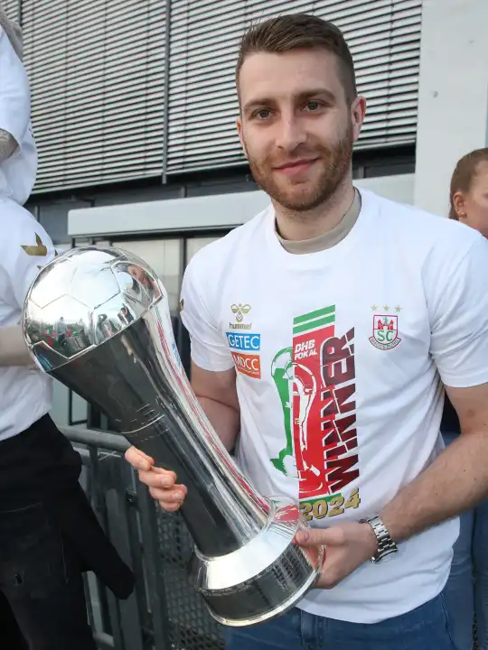 German handball player Lukas Mertens (SC Magdeburg) with trophy at the reception of the current DHB Cup winner 2024 SC Magdeburg on 15.04.2024 at the GETEC Arena Magdeburg