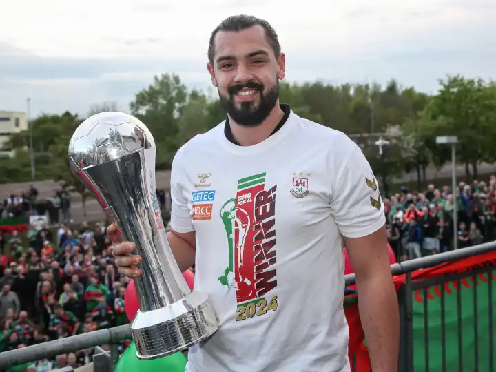 German handball goalkeeper Niclas Behrendt (SC Magdeburg) with trophy at the reception of the current DHB Cup winner 2024 SC Magdeburg on 15.04.2024 at the GETEC Arena Magdeburg