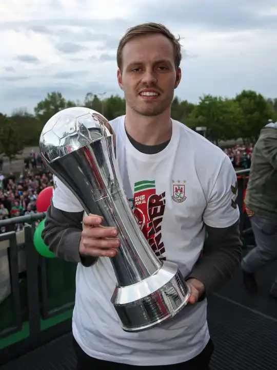 Icelandic handball player Omar Ingi Magnusson (SC Magdeburg) with trophy at the reception of the current DHB Cup winner 2024 SC Magdeburg on 15.04.2024 at the GETEC Arena Magdeburg